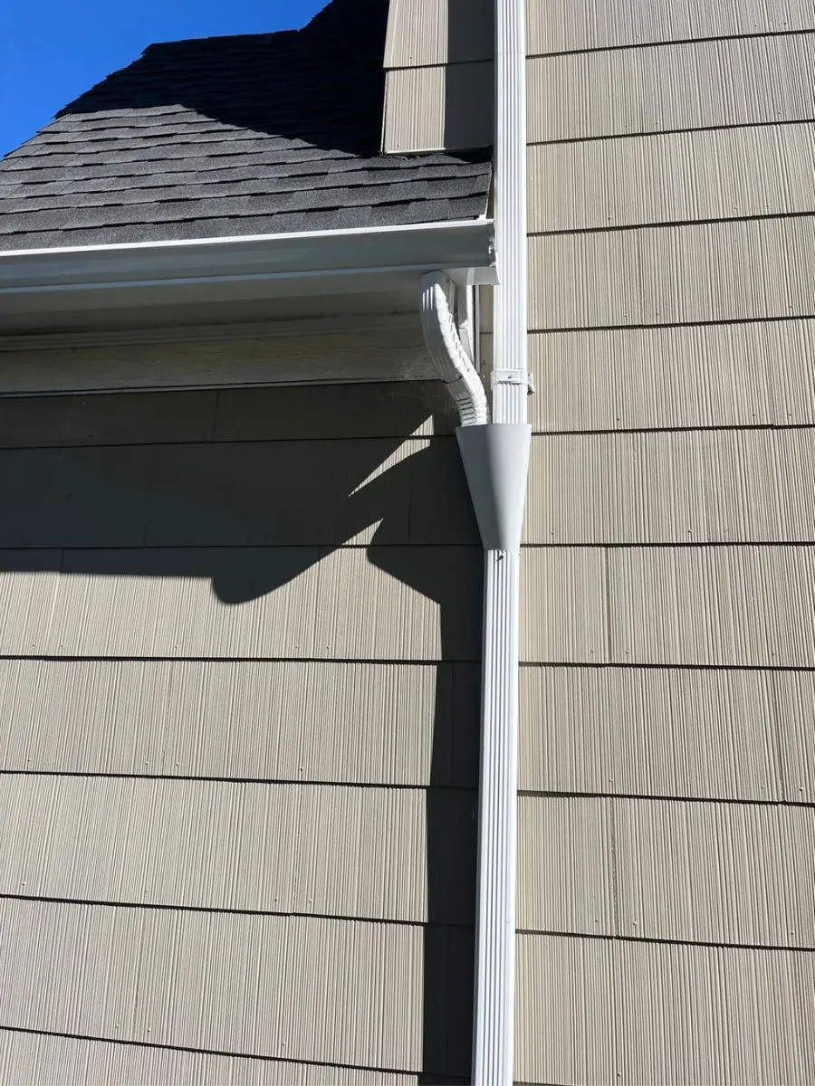 Residential rain gutter and white downspout on a Buffalo, NY home.