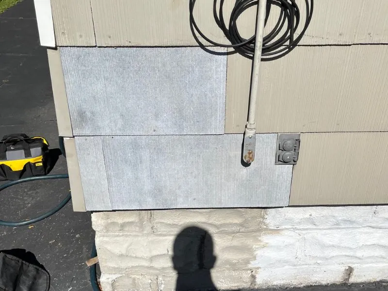 Exterior wall repair showing concrete siding panels and foundation on a home in Buffalo, NY