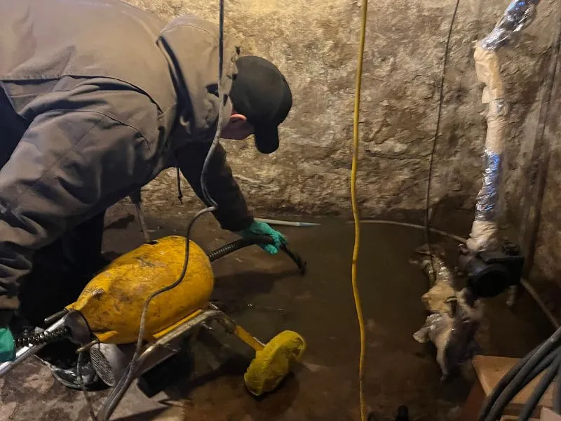 WorryFree technician inspecting a sewer line and preparing drain cleaning equipment