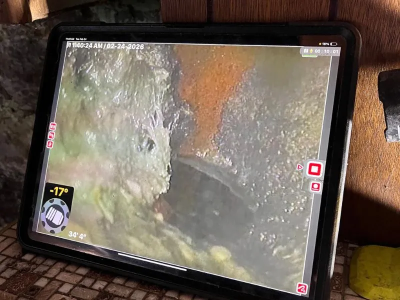 Sewer camera inspection monitor displaying the inside of a sewer line during a plumbing inspection