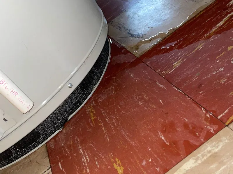 Water leaking around the base of a residential hot water heater in a Buffalo, NY home.