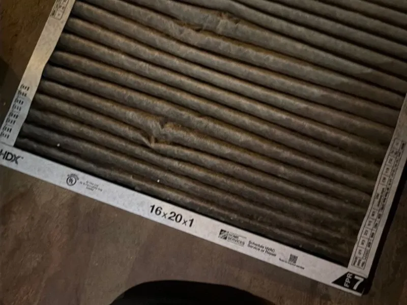Dirty furnace air filter showing the importance of regular heating system maintenance.
