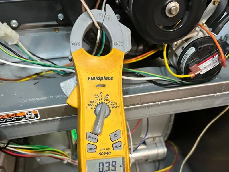 Furnace diagnostic testing with a digital electrical meter during heating system service.