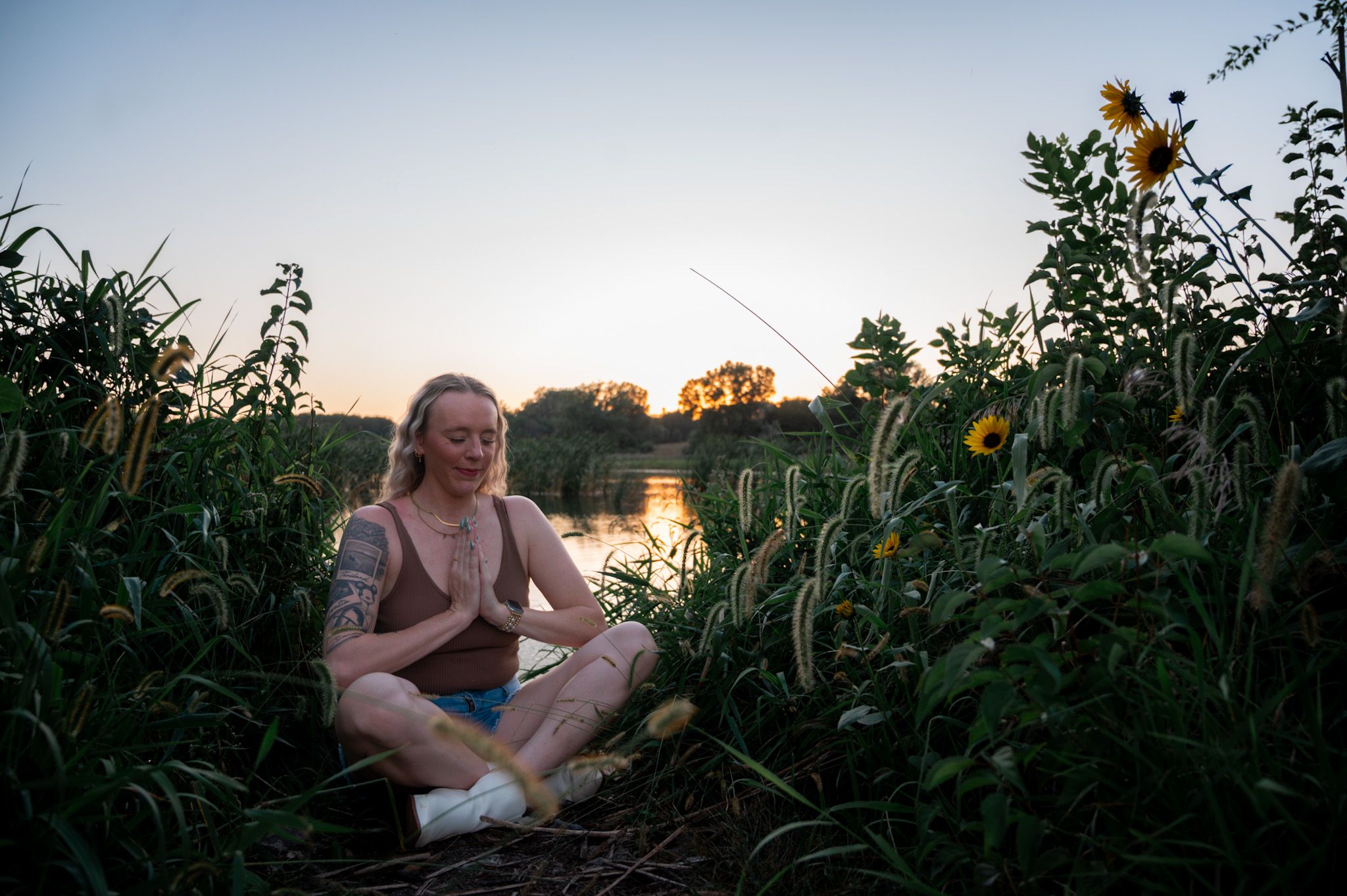 Portrait of Tiff, a woman in her late 30s with warm brown skin, short curly hair, wearing a soft pink blouse, smiling gently against a neutral background. 1:1 aspect ratio.