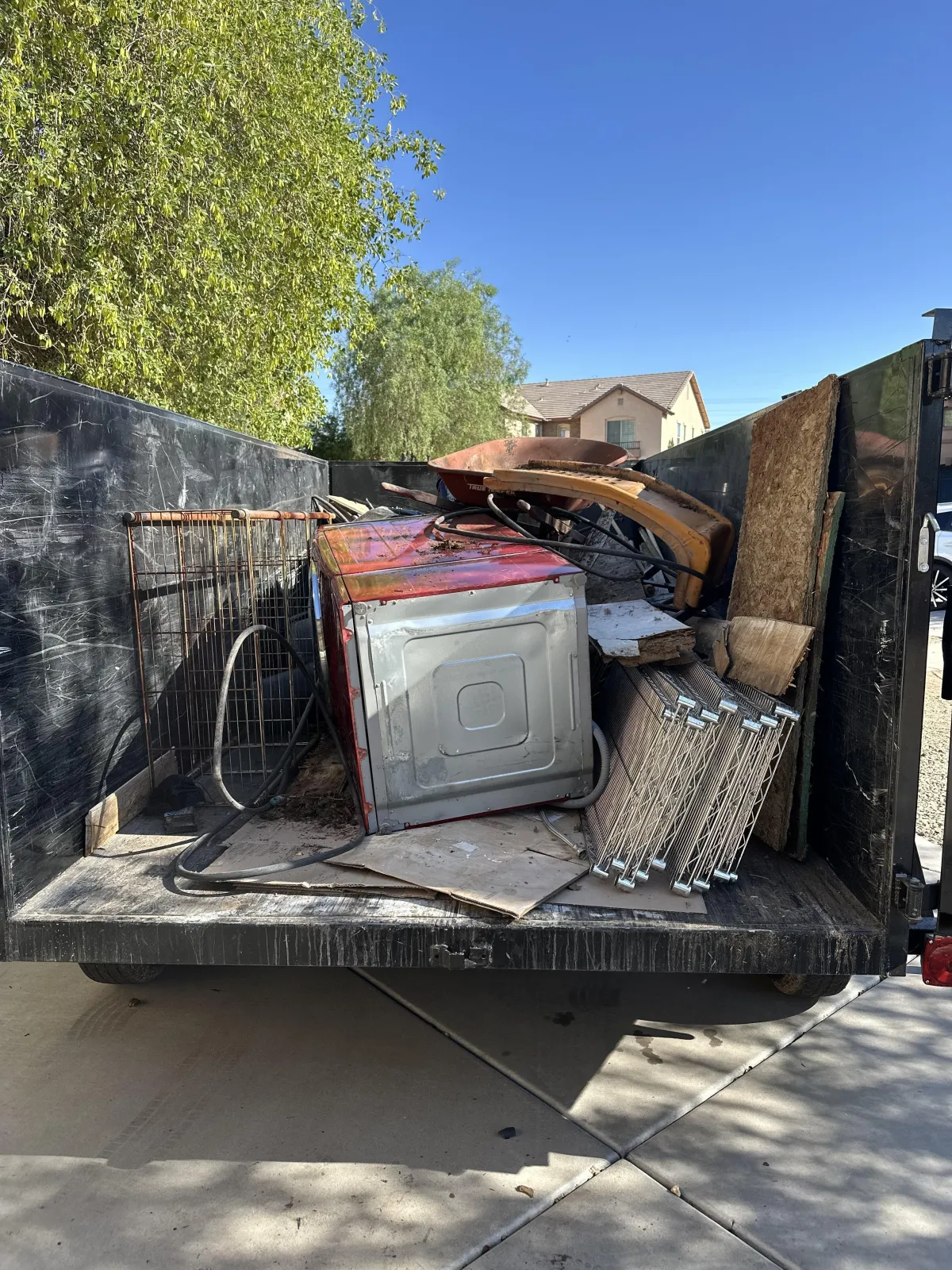 Junk removal trailer full of appliances, cardboard, and trash in Phoenix.