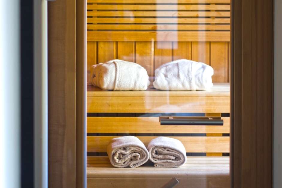 Modern custom wood sauna interior with bench seating and lighting