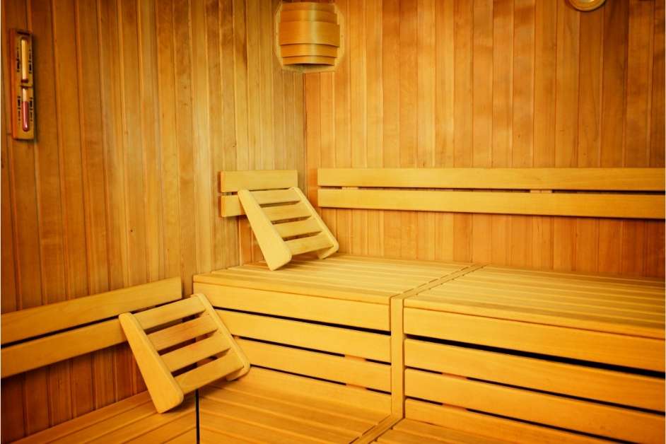 Modern custom wood sauna interior with bench seating and lighting