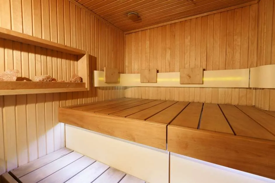 Custom sauna interior with heater and wood benches