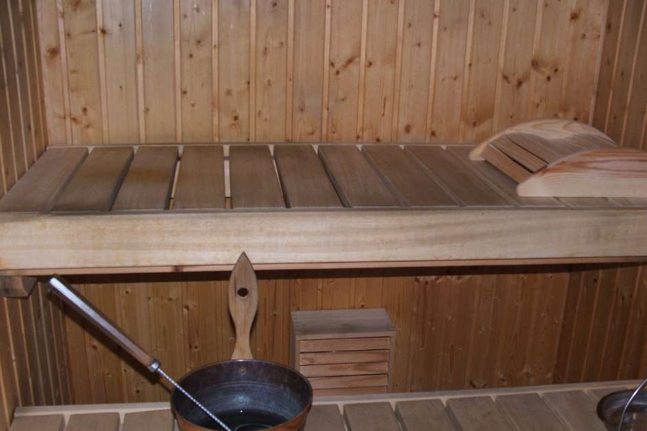 Modern custom wood sauna interior with bench seating and lighting