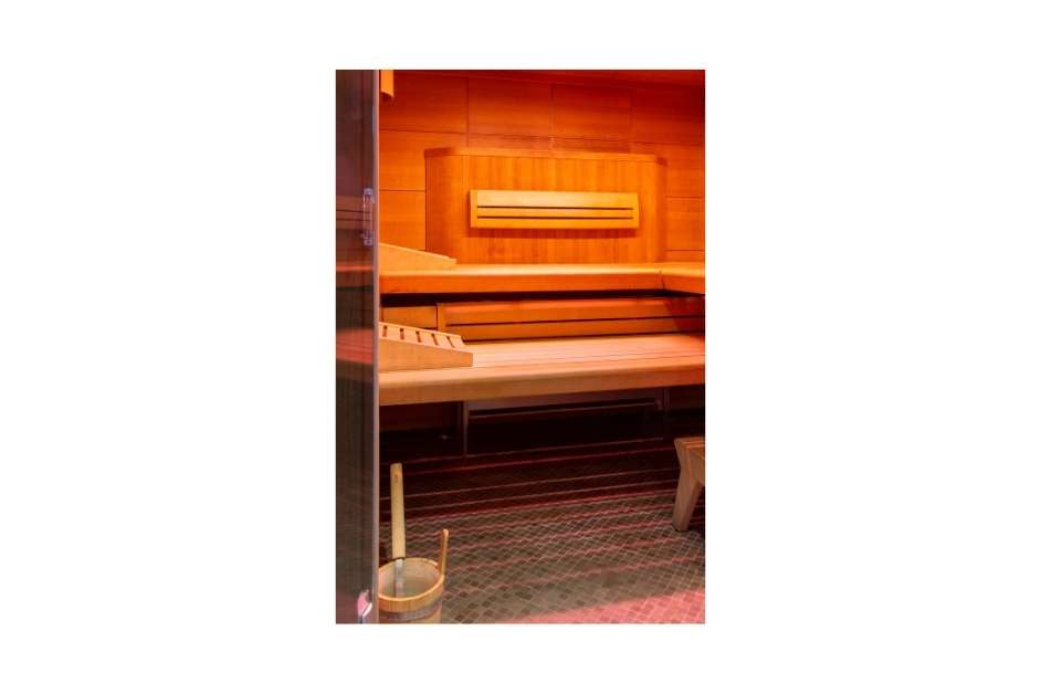 Luxury custom wood sauna interior with bench seating and lighting