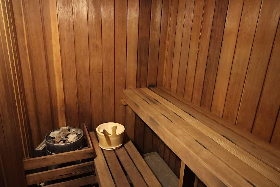 Modern custom wood sauna interior with bench seating and lighting