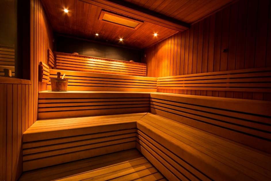 Modern custom wood sauna interior with bench seating and lighting