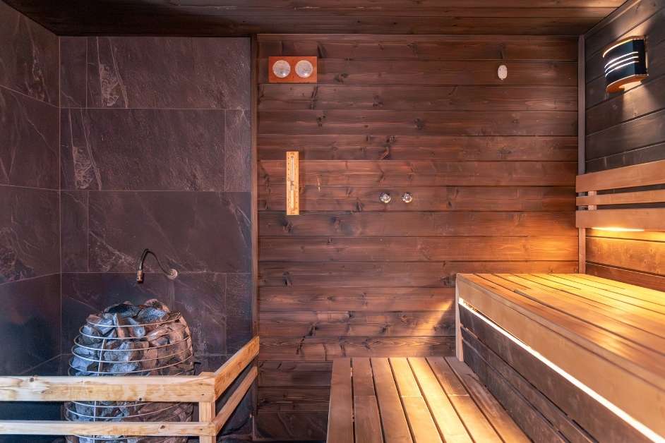 Indoor sauna interior with heater and cedar walls