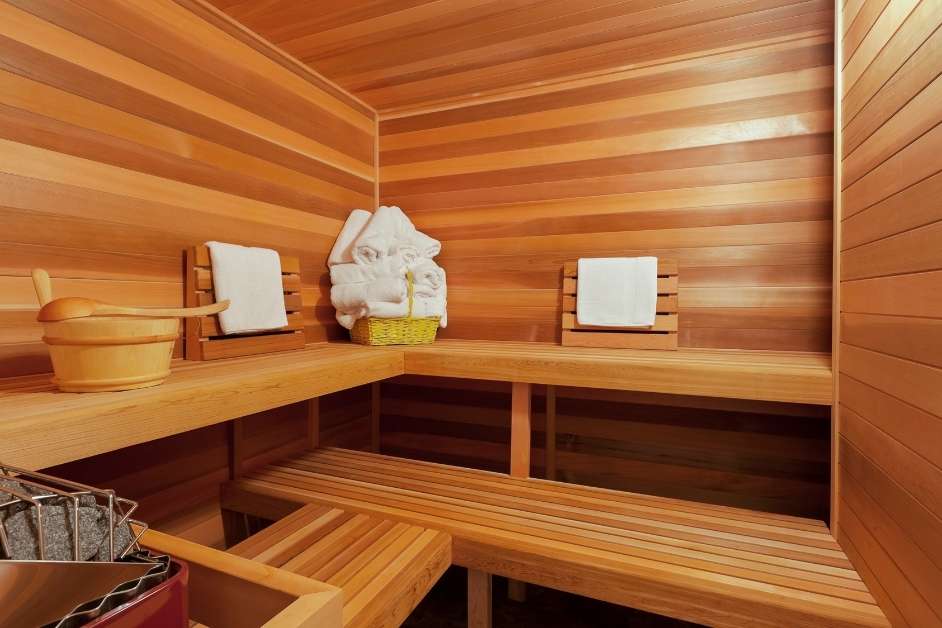 Luxury custom wood sauna interior with bench seating and lighting