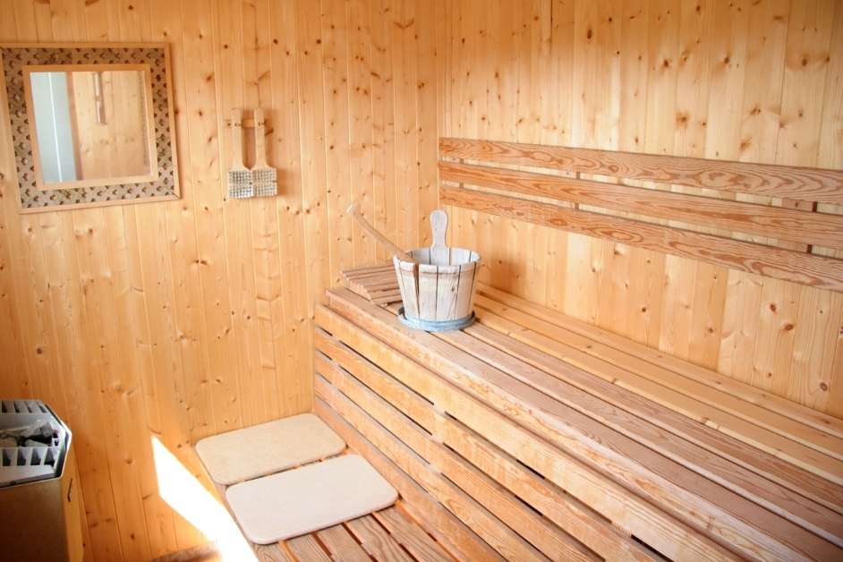 Indoor sauna with cedar paneling and lighting
