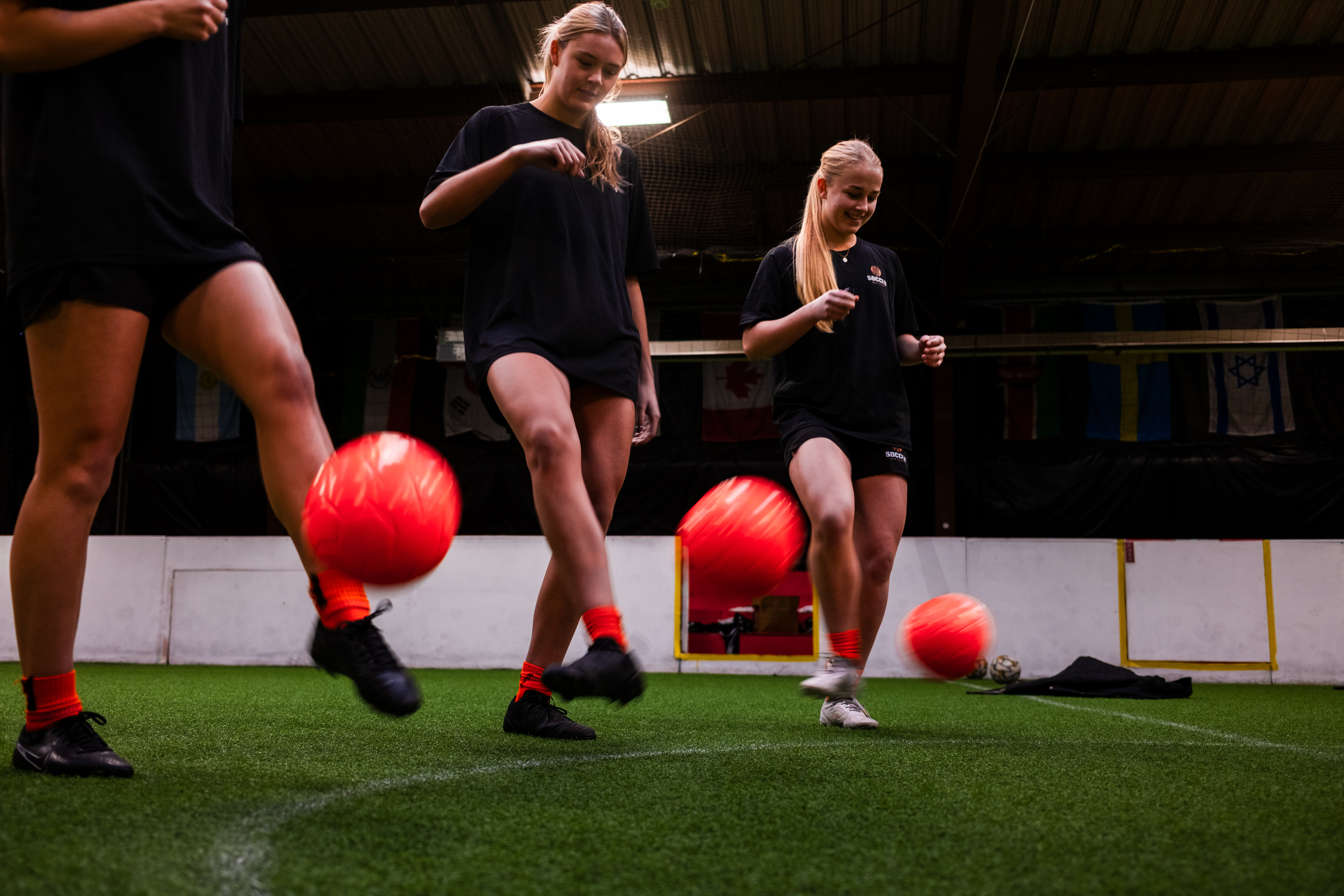 Kids playing soccer with a coach during practice