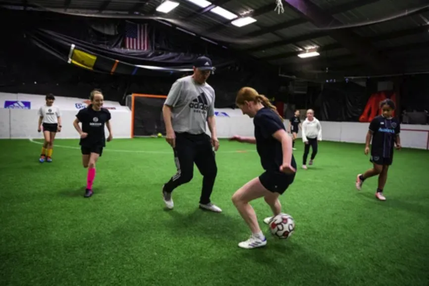 Soccer coach high‑fiving a young player