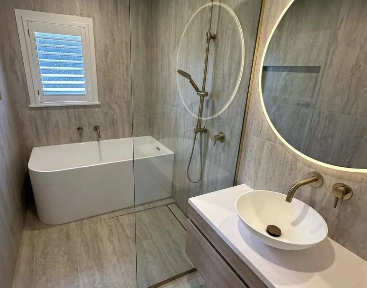 man in orange and black vest wearing white helmet holding yellow and black power tool