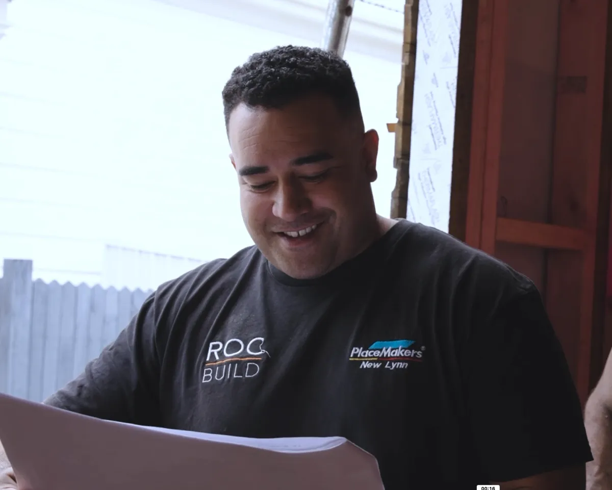 grayscale photo of crane in front of building