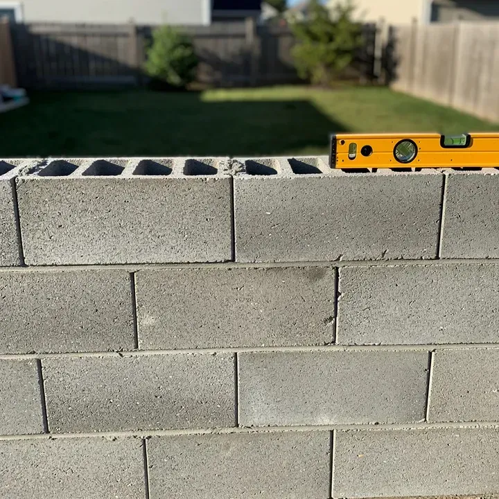 Freshly laid concrete block wall courses with clean mortar joints at a residential property in Kent, Ohio, partially completed on a sunny day in Kent, Ohio