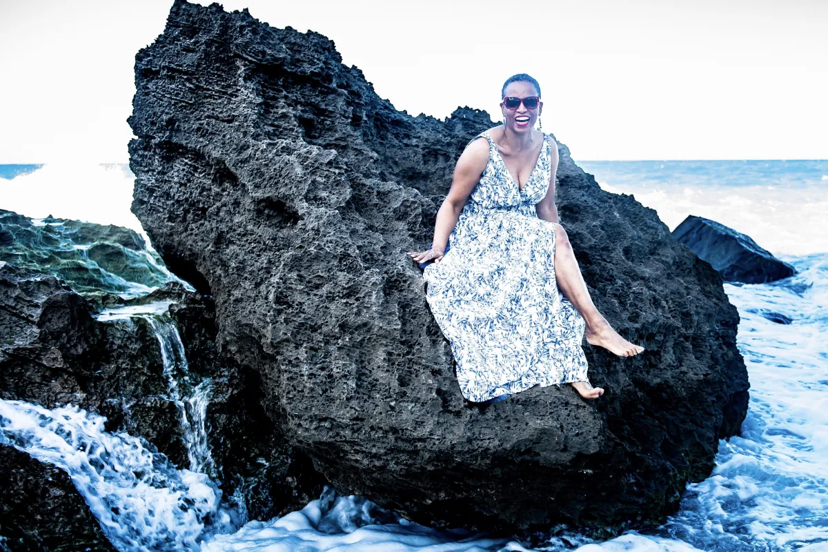 grayscale photo of 3 women sitting on wooden bench