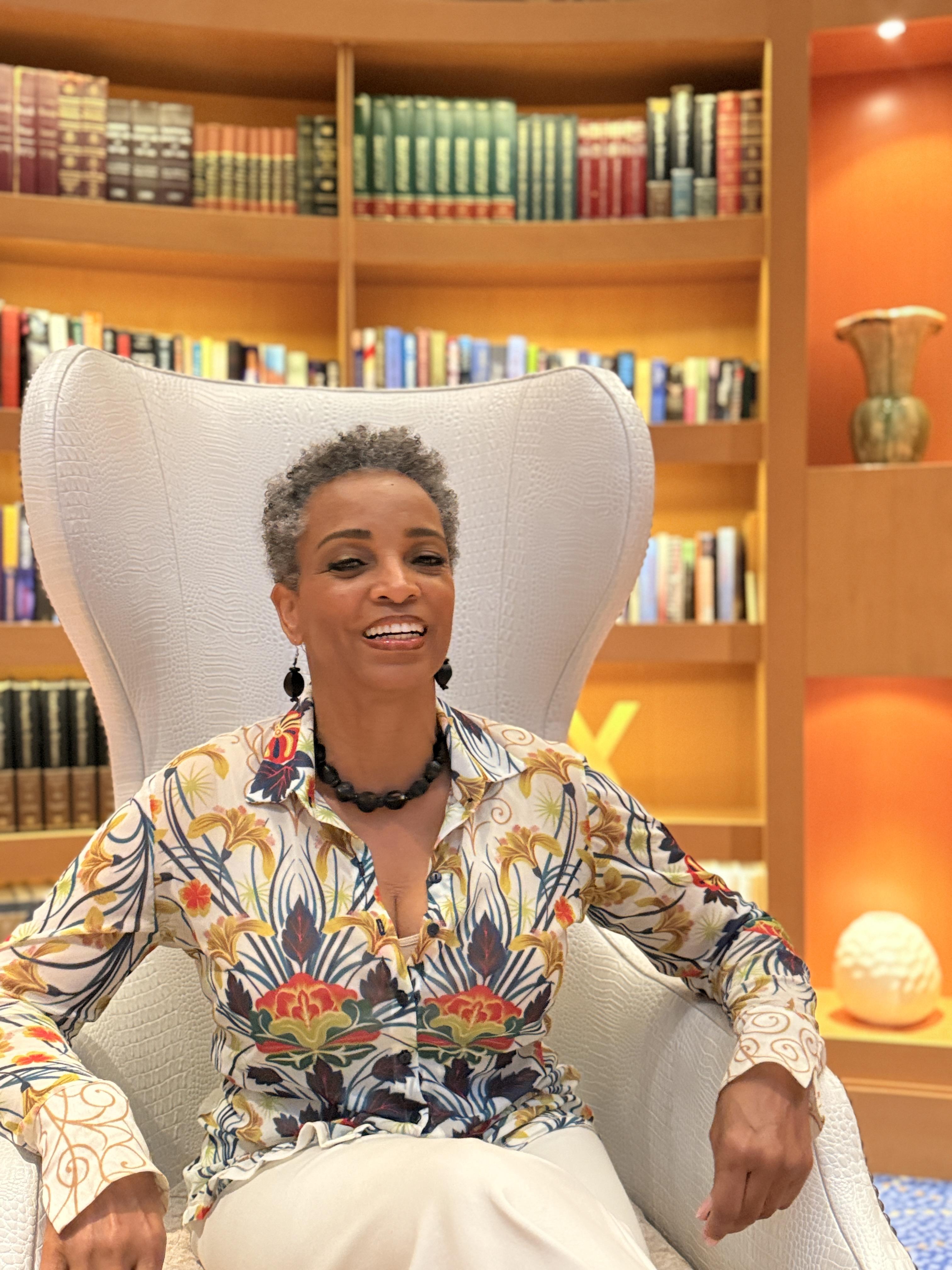grayscale photo of 3 women sitting on wooden bench