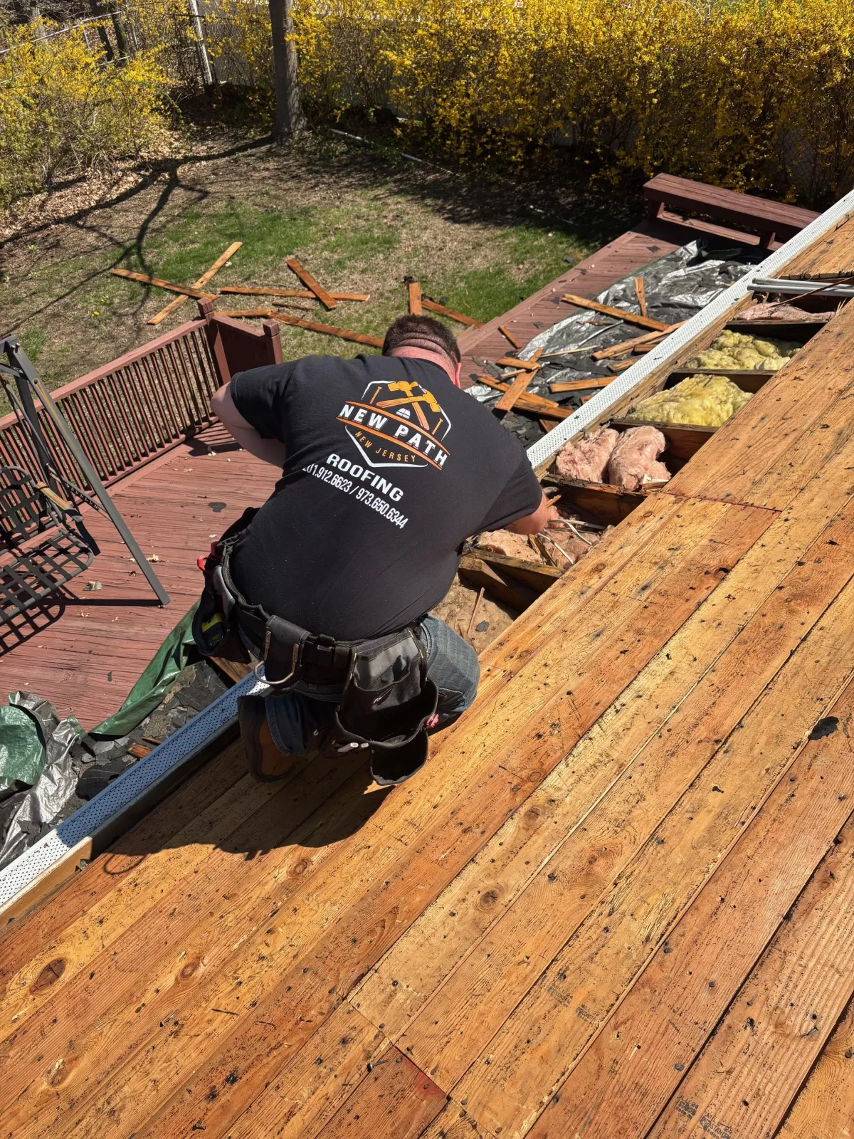 Routine roof maintenance performed on a residential home in Essex County, NJ by New Path Roofing, including gutter cleaning and shingle inspection.