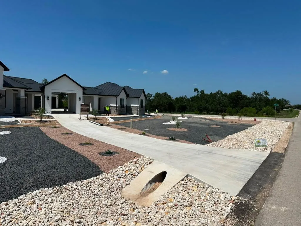 New concrete driveway and walkway at a residential property.