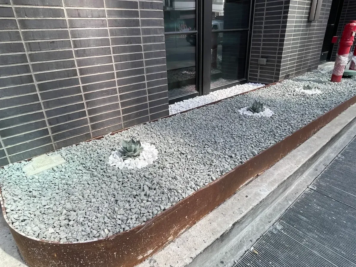 Low-maintenance xeriscape landscaping with decorative rock and plants.