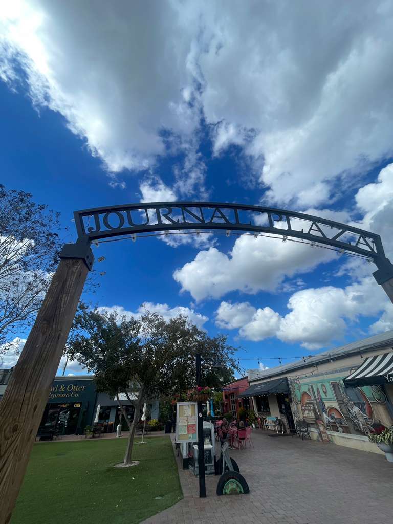a modern house with a pool and lounge chairs