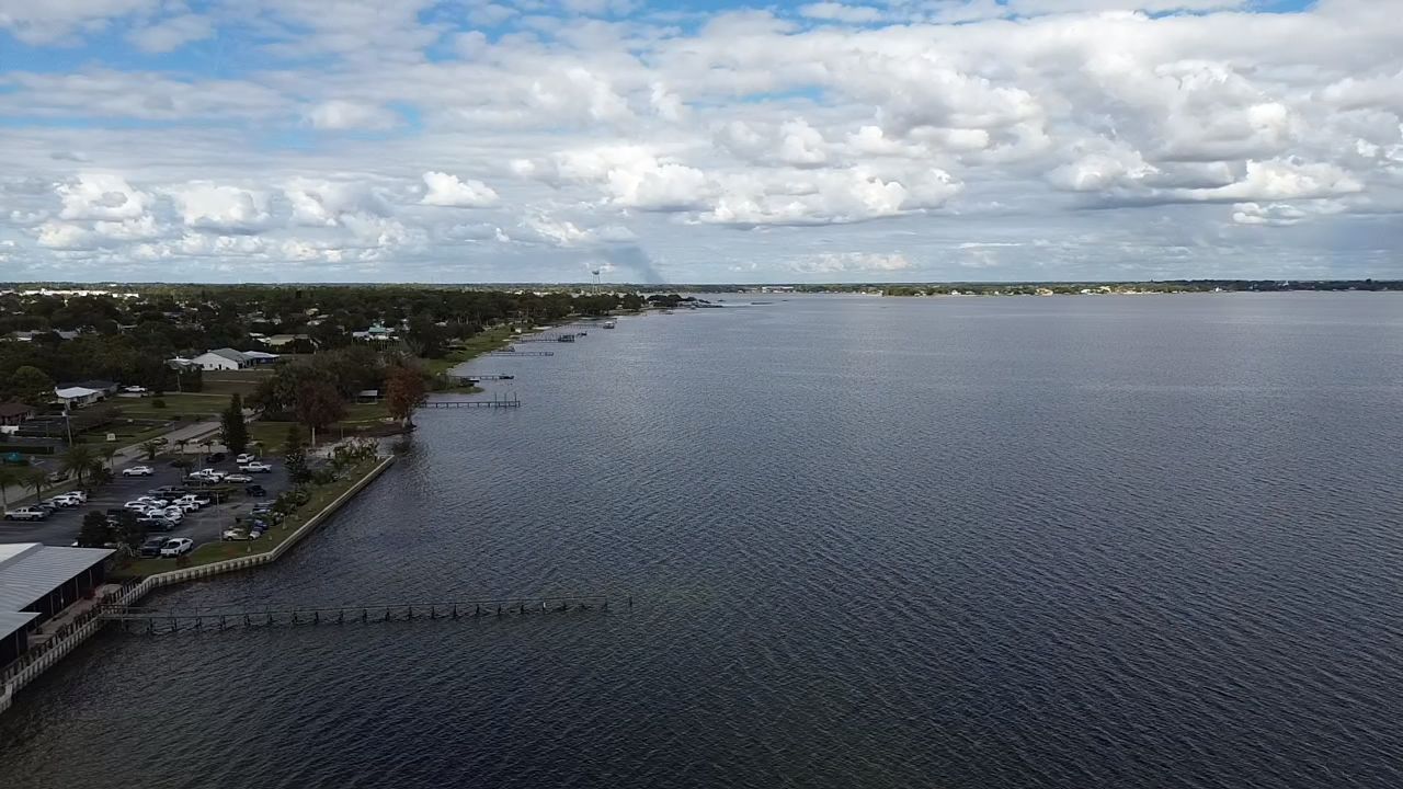 a modern house with a pool and lounge chairs