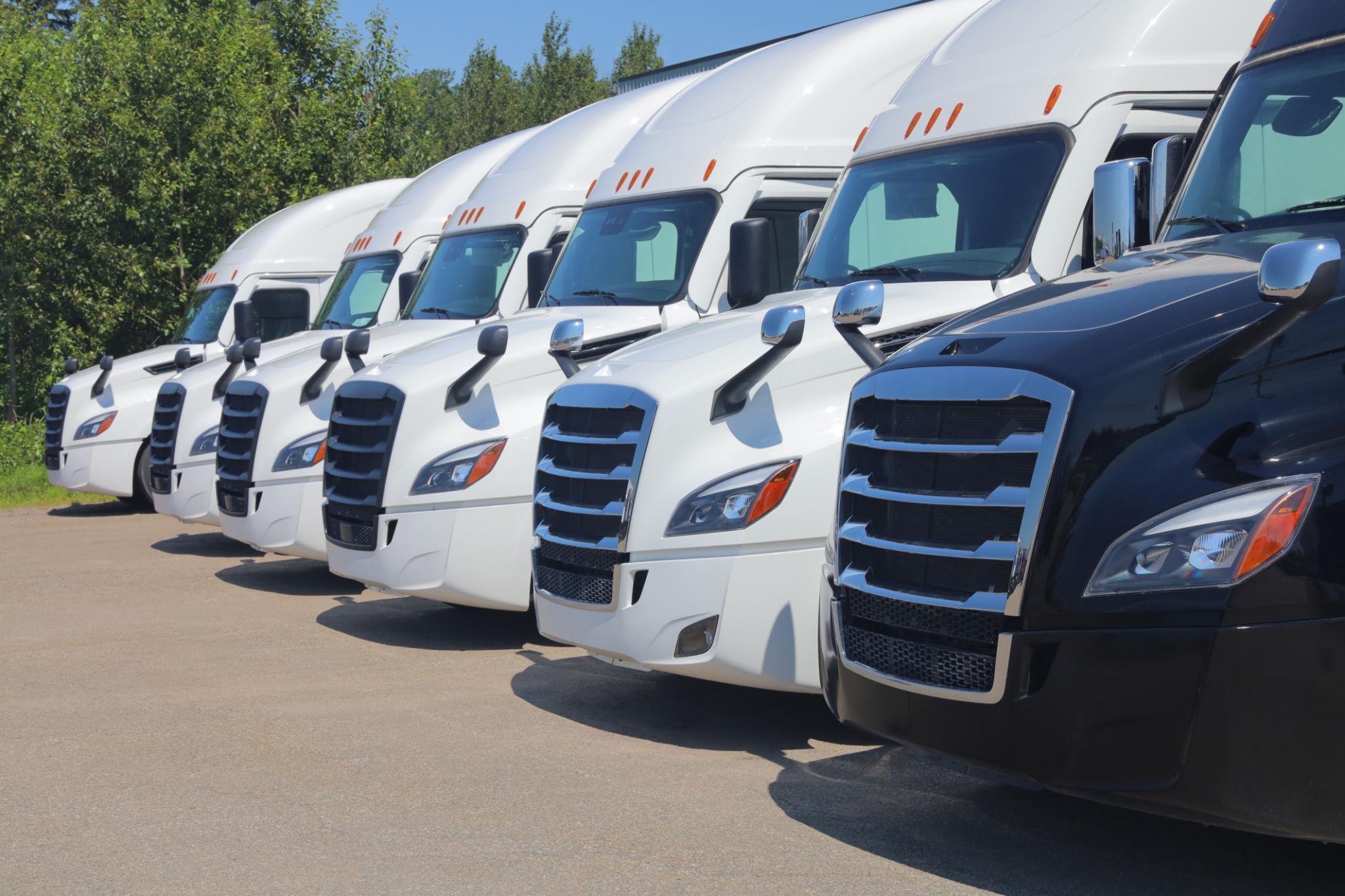 Airplane taxiing on a runway with buildings in background