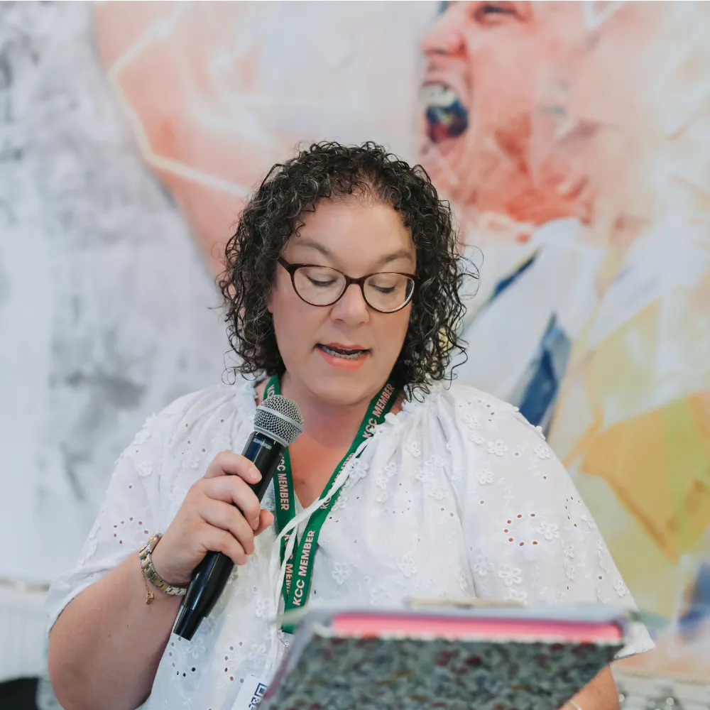 donna gillies supporting an event by talking in a microphone