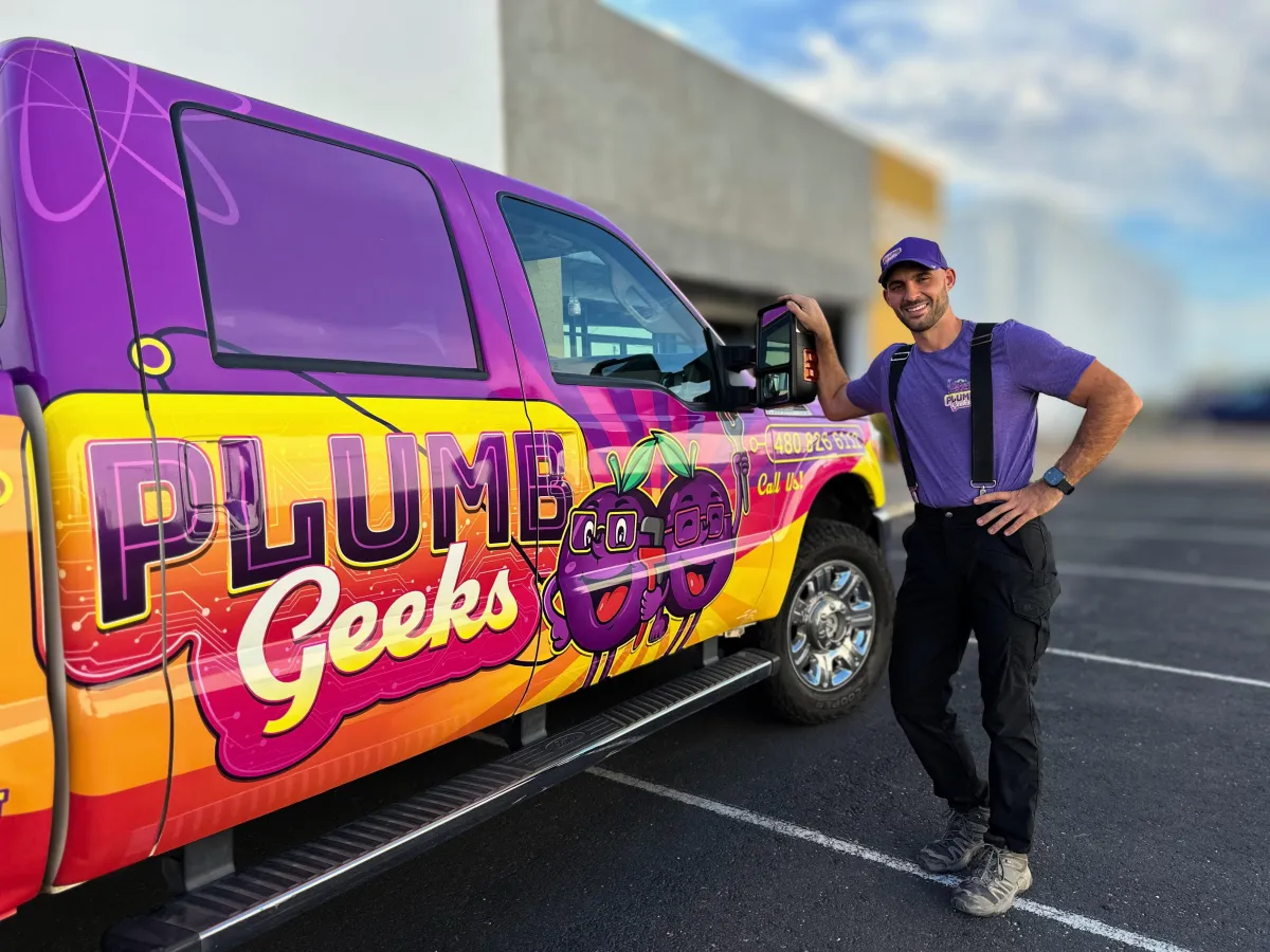 Plumbing talking to woman in kitchen. 