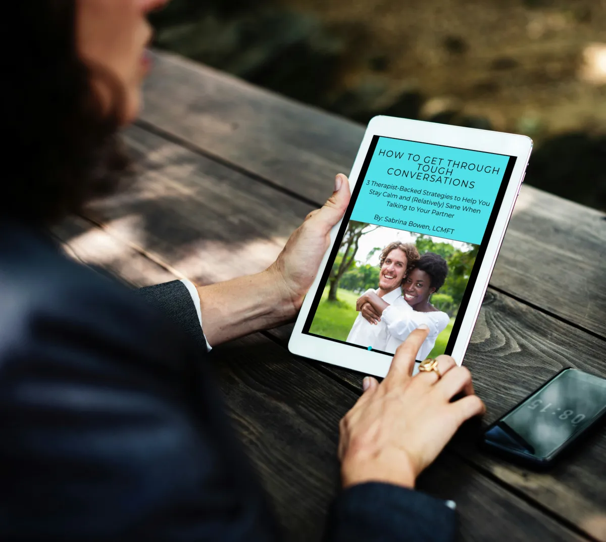 Woman reading the ‘How to Get Through Tough Conversations’ communication guide, a free relationship resource created by therapist Sabrina Bowen.