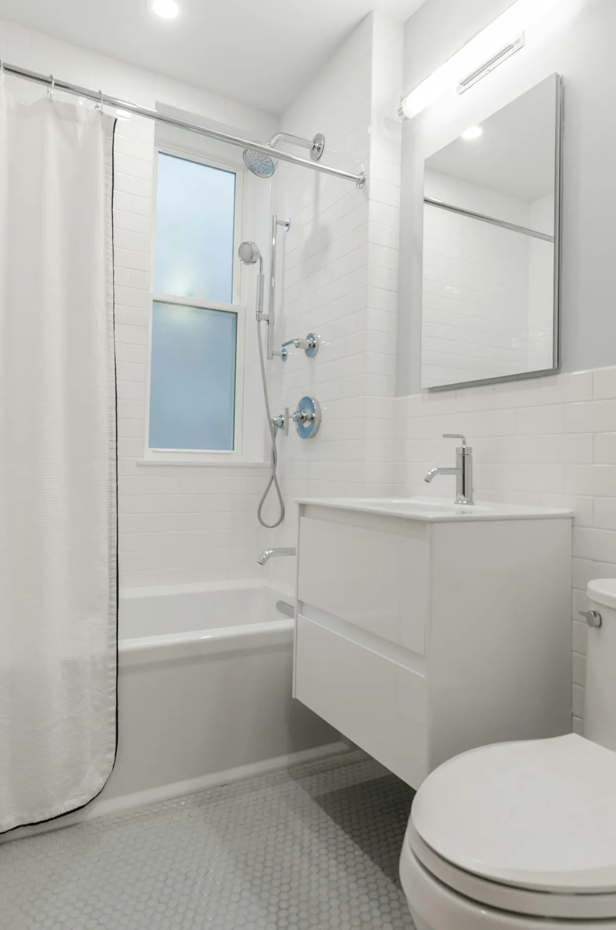 white and silver clean bathroom with shower tub