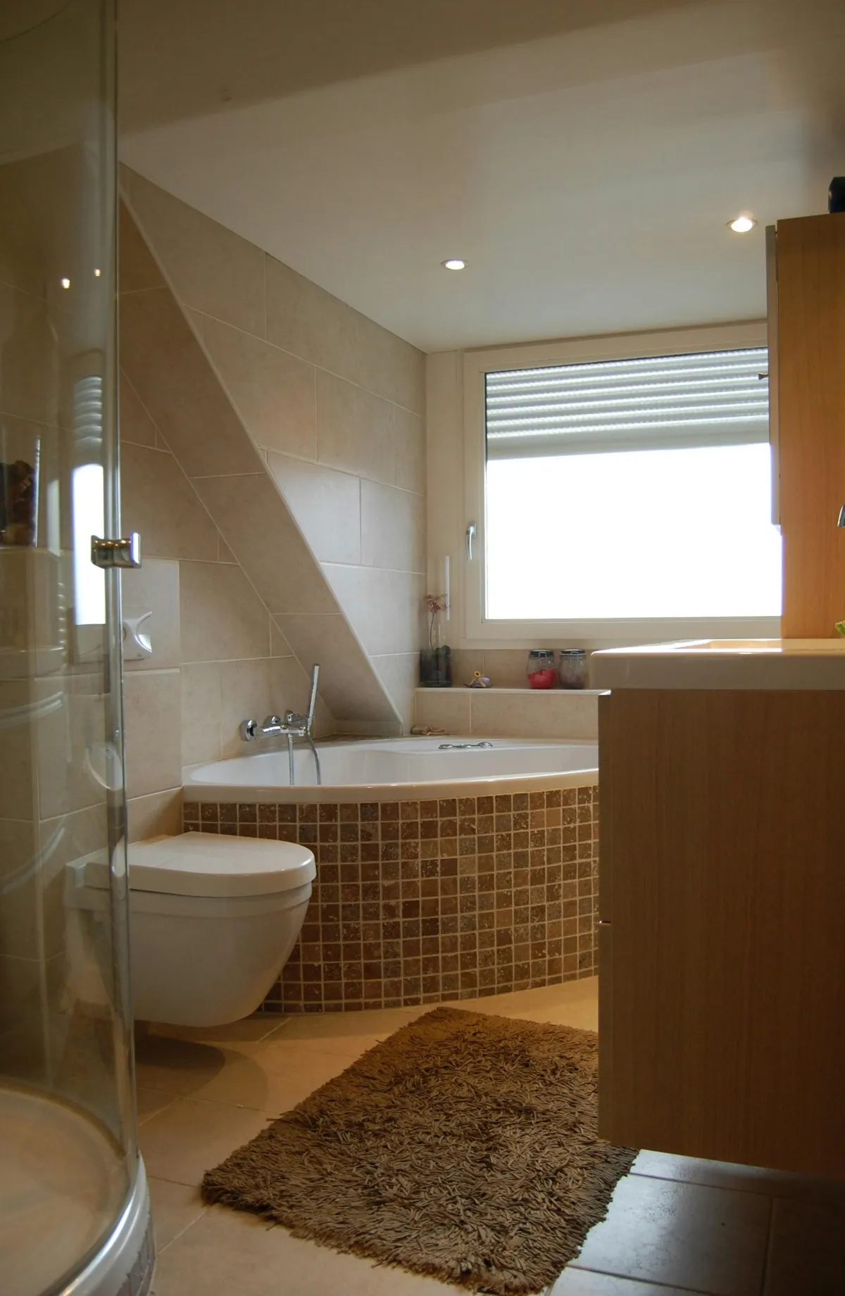white marble walls with black hexagon tiles with two gold framed mirrors and white vanity