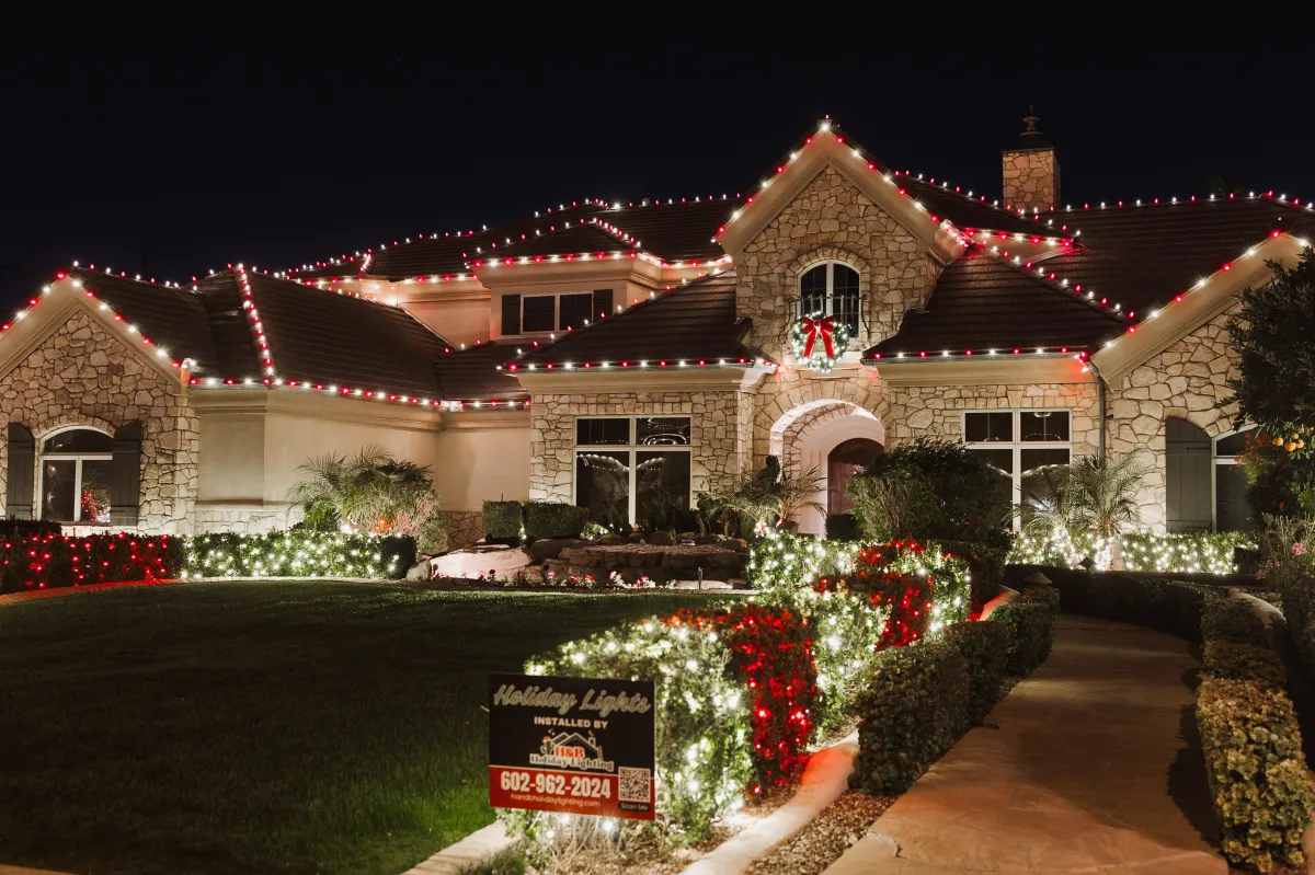Holiday decorator placing ornaments on a luxury Christmas tree with precision