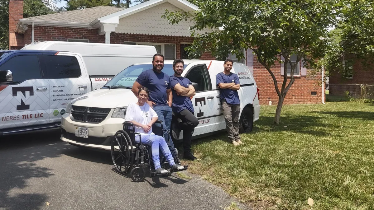 Team members of Neres Tile LLC posing in front of their service vehicles, showcasing their commitment to quality tile and flooring installation in Richmond, VA.