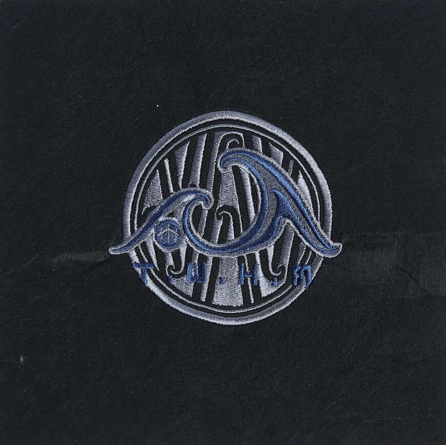 Blue, grey and white circular wave logo embroidered on black fabric