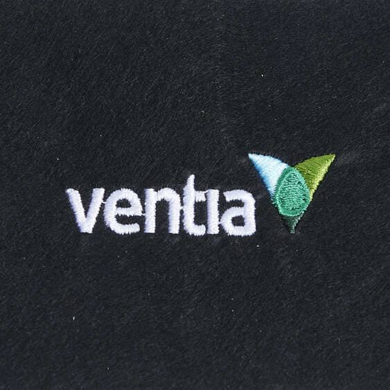 White Venta wordmark with green and blue embroidered symbol on black fabric