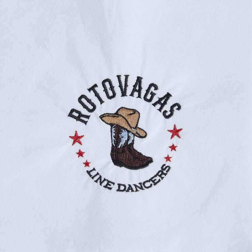 Embroidered Rotovagas Line Dancers logo with cowboy boot and red stars on white fabric