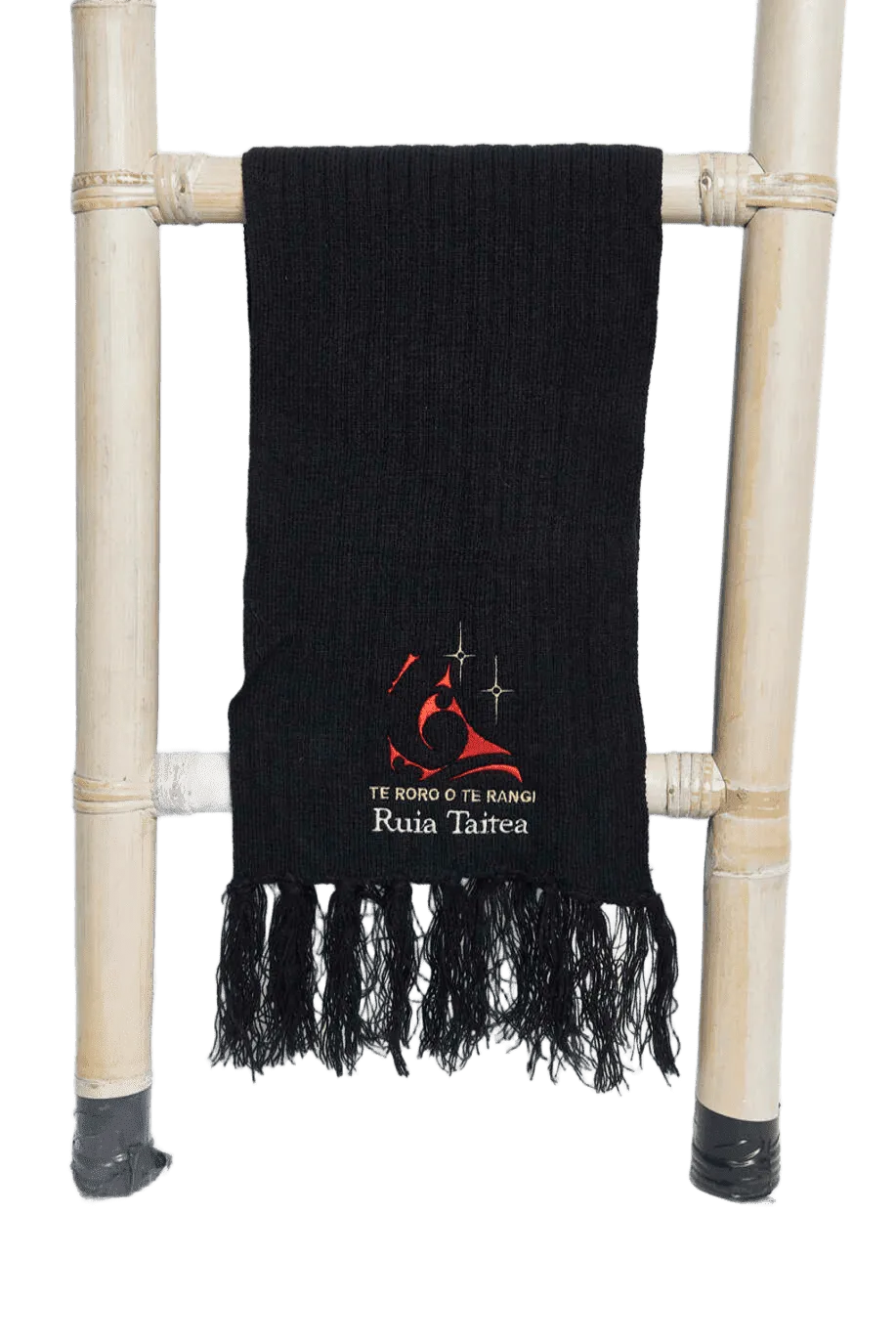 Black fringed scarf with Te Roro o Te Rangi Ruia Taitea branding
