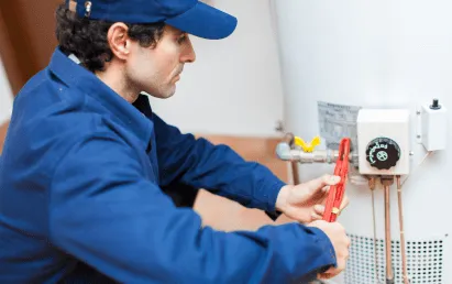 Licensed plumber in San Antonio repairing a water heater