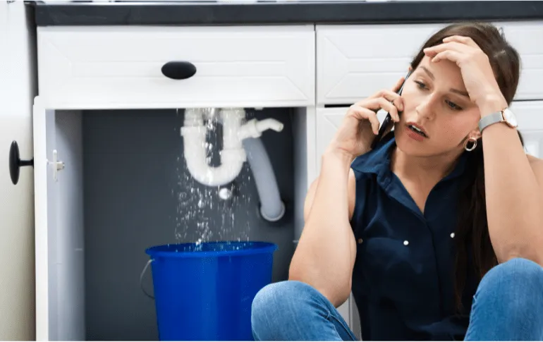 Woman calling an emergency plumber for a leaking sink – 24/7 emergency plumbing services in San Antonio, TX by 2nd Opinion Plumbing.