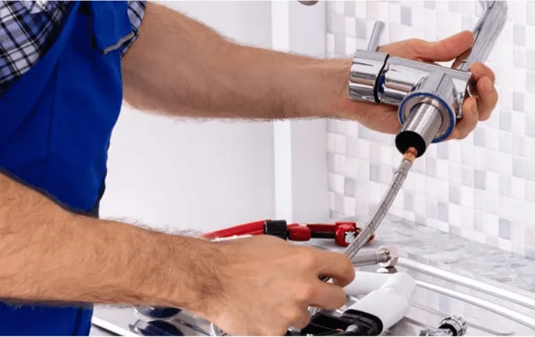 Plumber installing a bathroom faucet – Professional fixture installation services in San Antonio, TX by 2nd Opinion Plumbing.