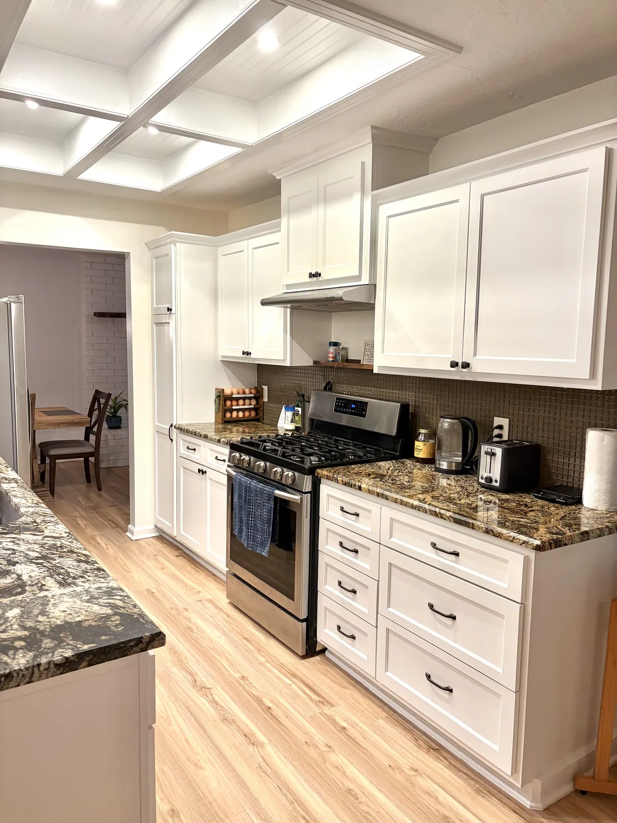 Bright renovated kitchen with shaker cabinets and granite countertops