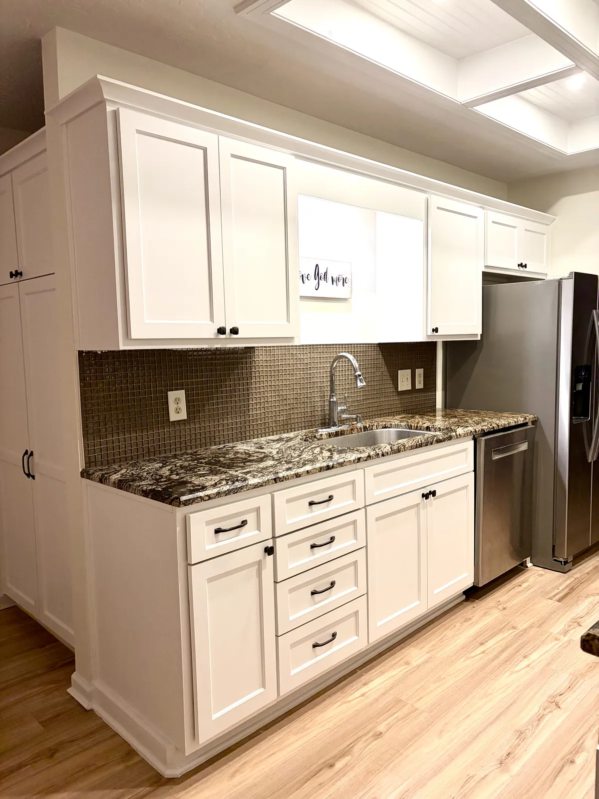 Bright renovated kitchen with shaker cabinets and granite countertops