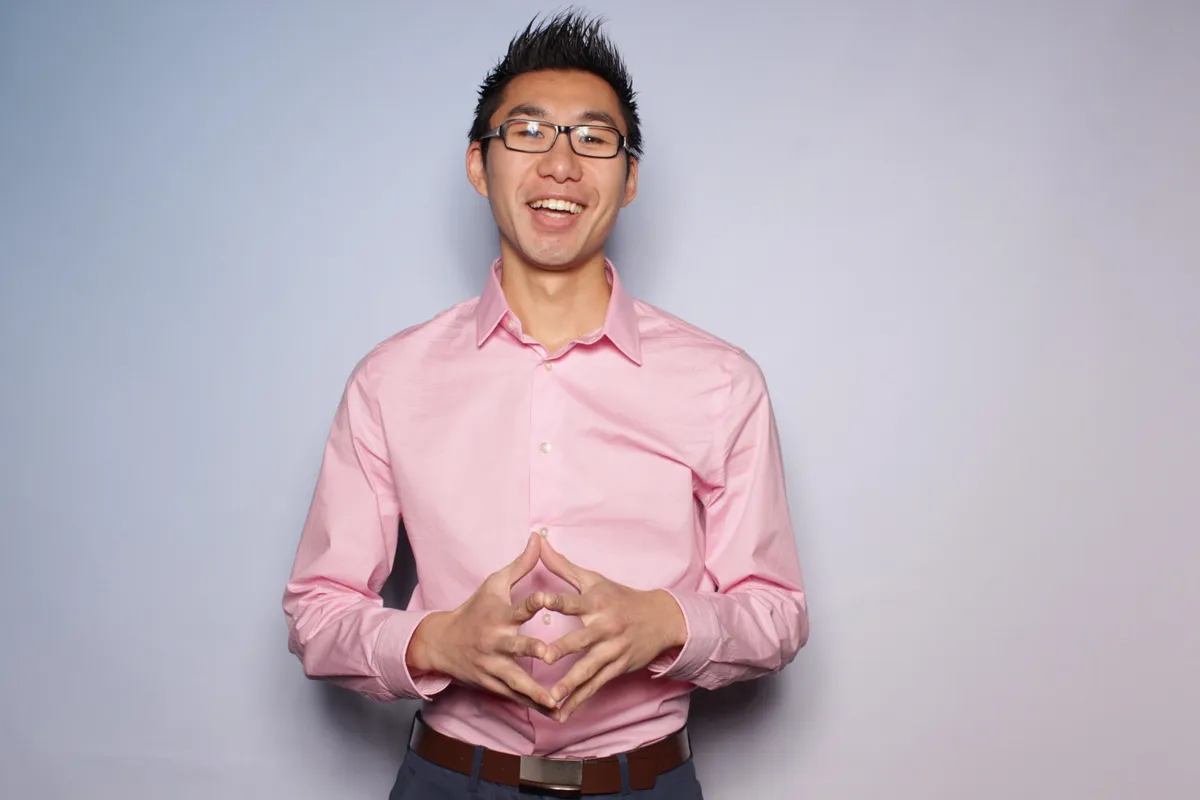 Kit Pang, founder of BostonSpeaks, smiling in a pink shirt