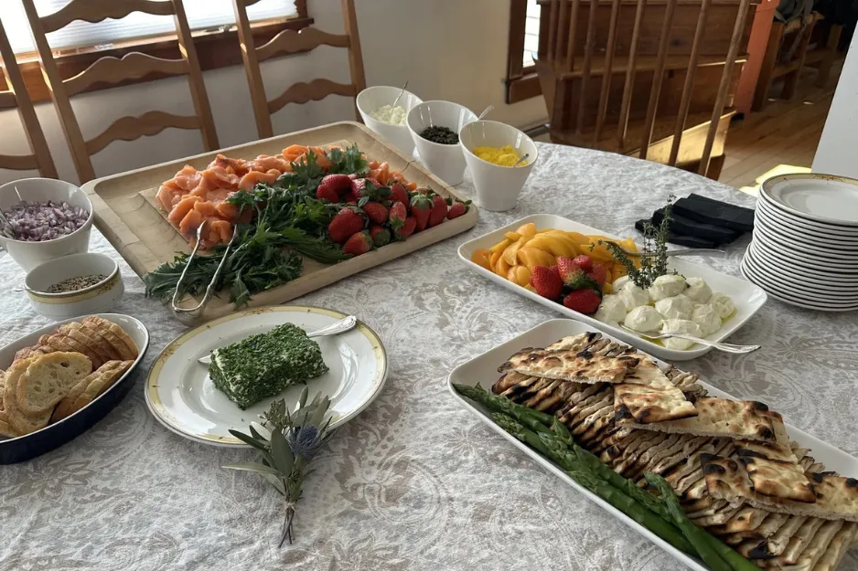 A private chef plating a gourmet, chef-driven dinner for an intimate home gathering or vacation rental in Southern New Hampshire.